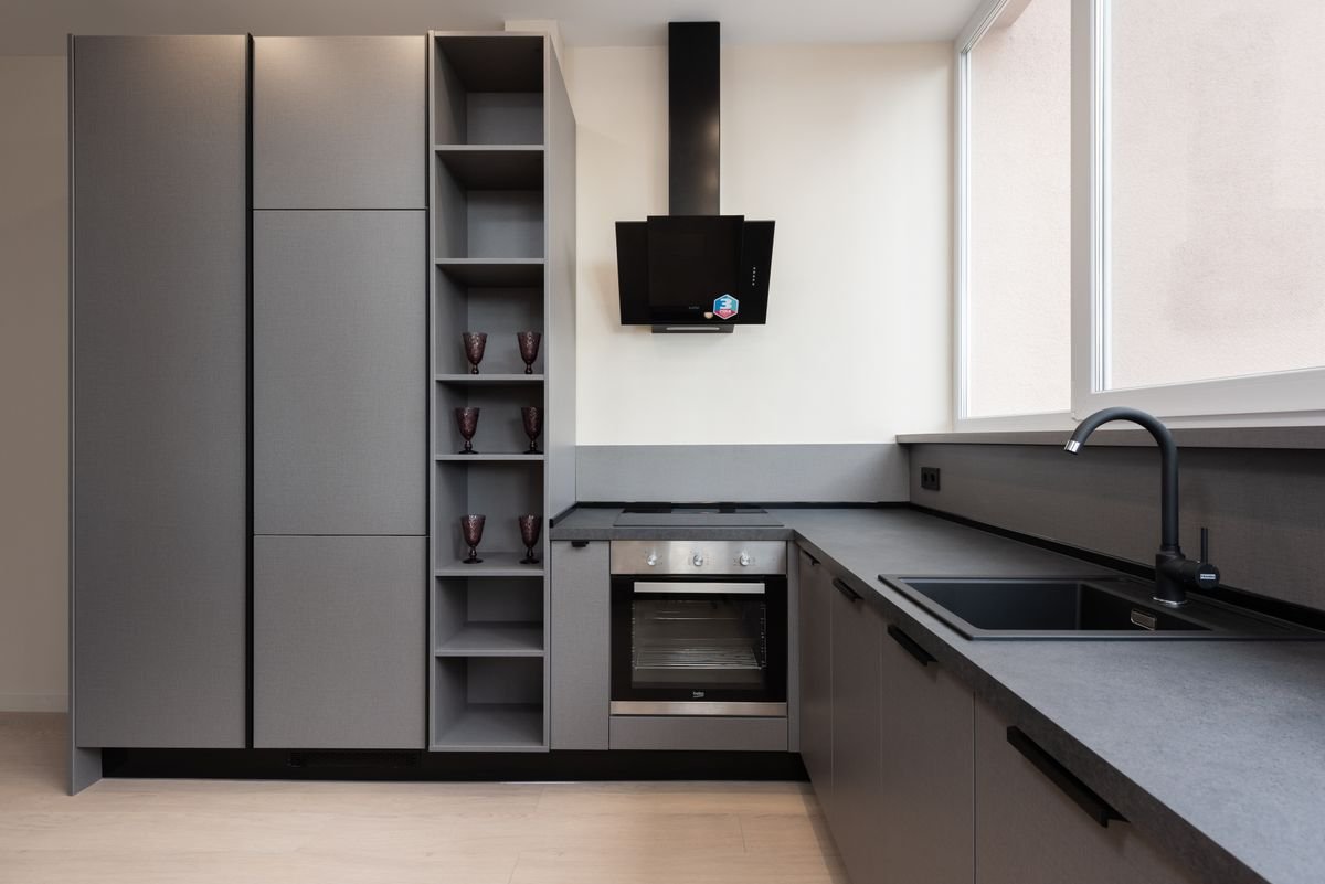 Modern kitchen with gray cabinets and built-in appliances