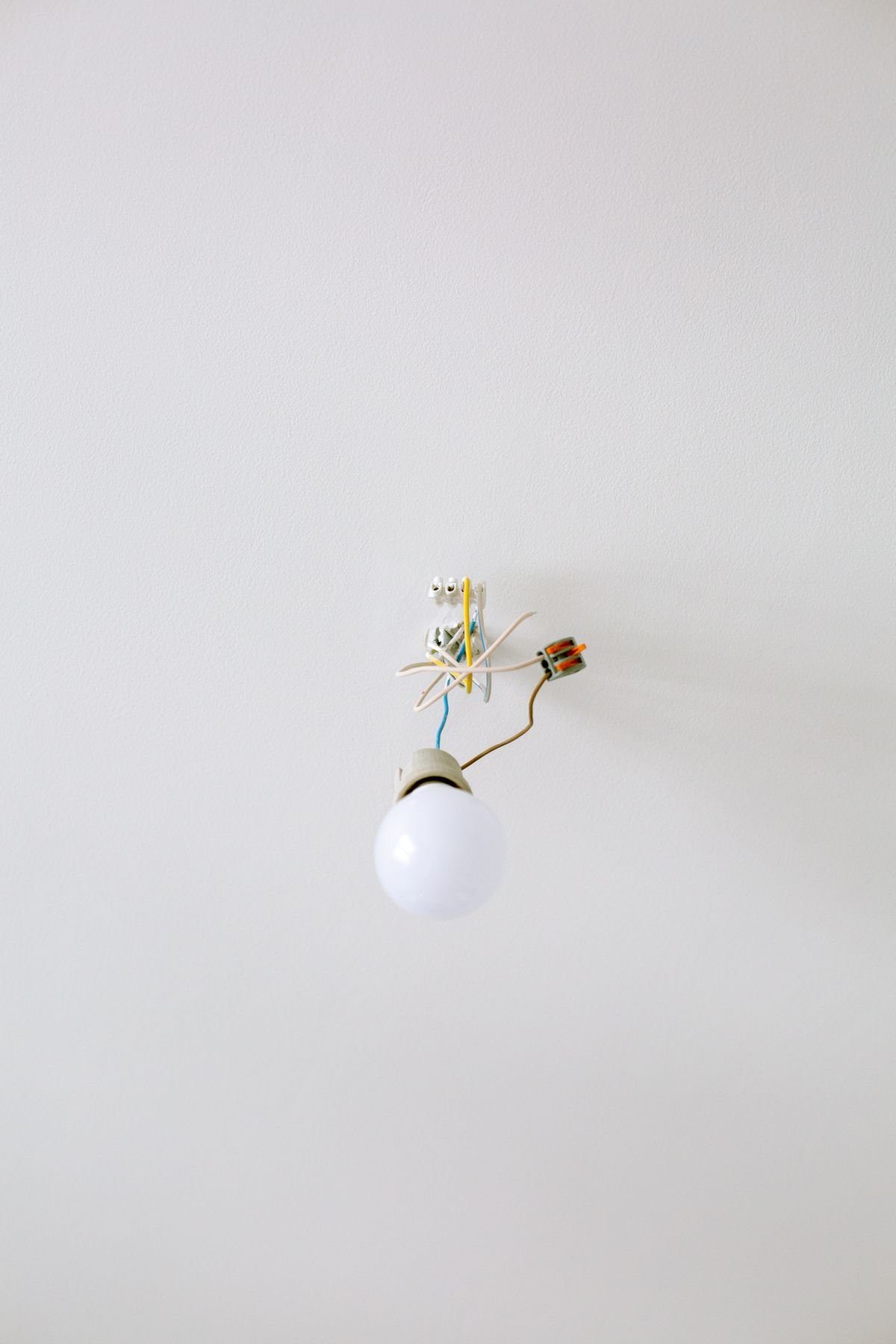 A light bulb fixture with exposed wiring ready for installation