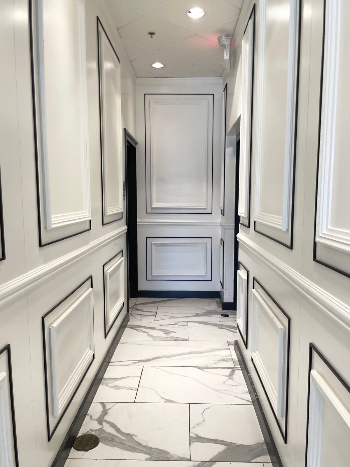 Clean white marble hallway floor with veined pattern
