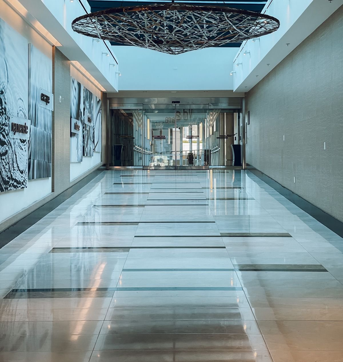 Bright commercial corridor with spotless reflective marble flooring
