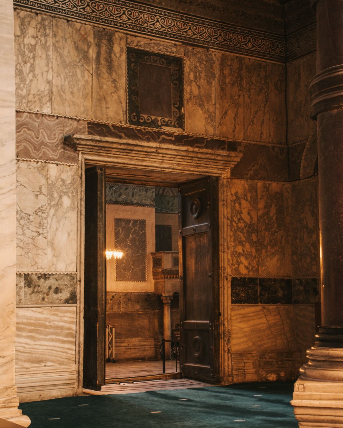 Marble interior with a carved wooden doorway in a historic building