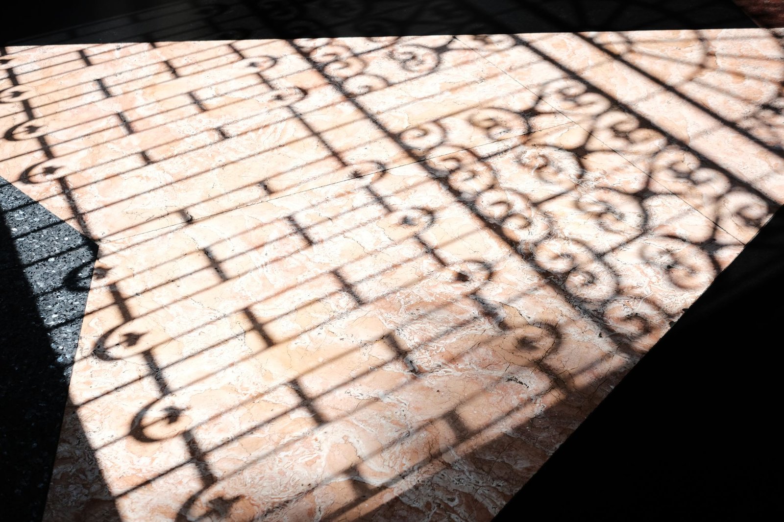 Glossy reflective marble floor showing a mirror-like shine with light and shadow patterns