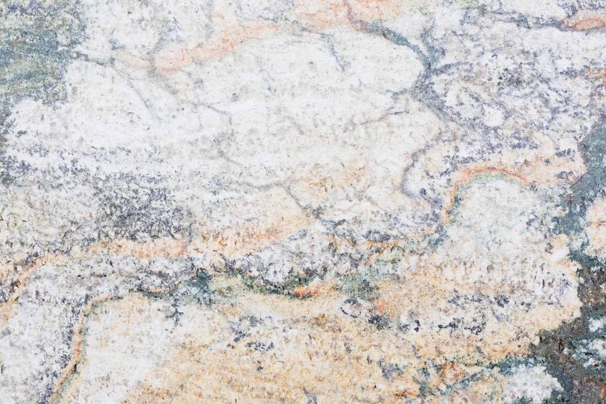 Close-up of beige marble with natural orange and grey veining