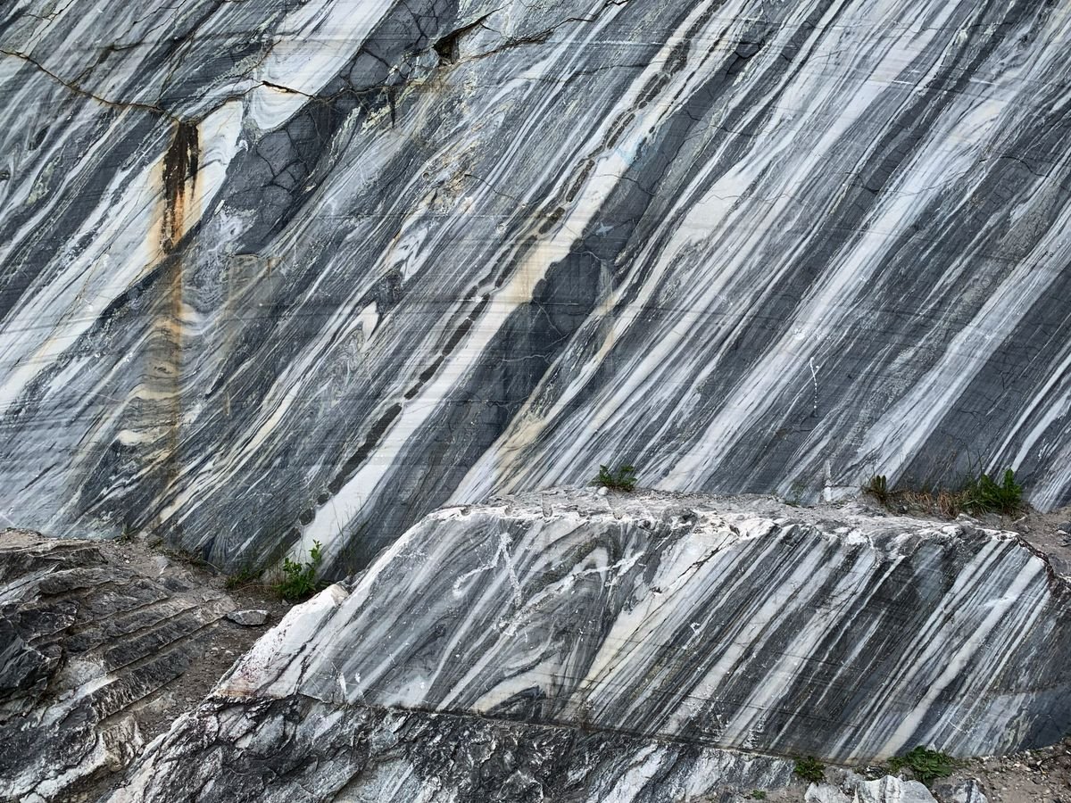 Raw striped marble stone surface showing natural grain before finishing