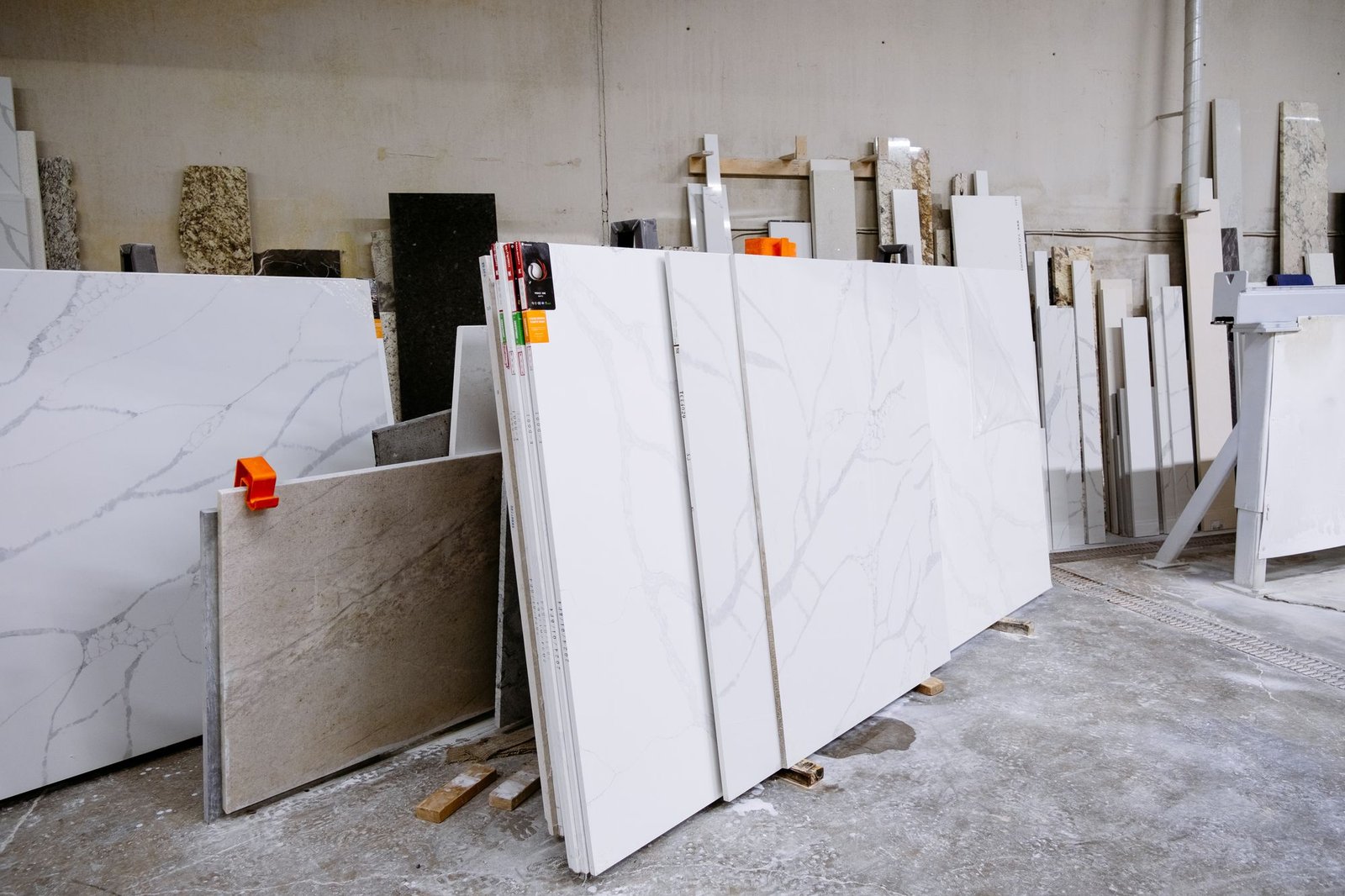 Wide view of marble and granite slabs racked in a stone warehouse ready for selection