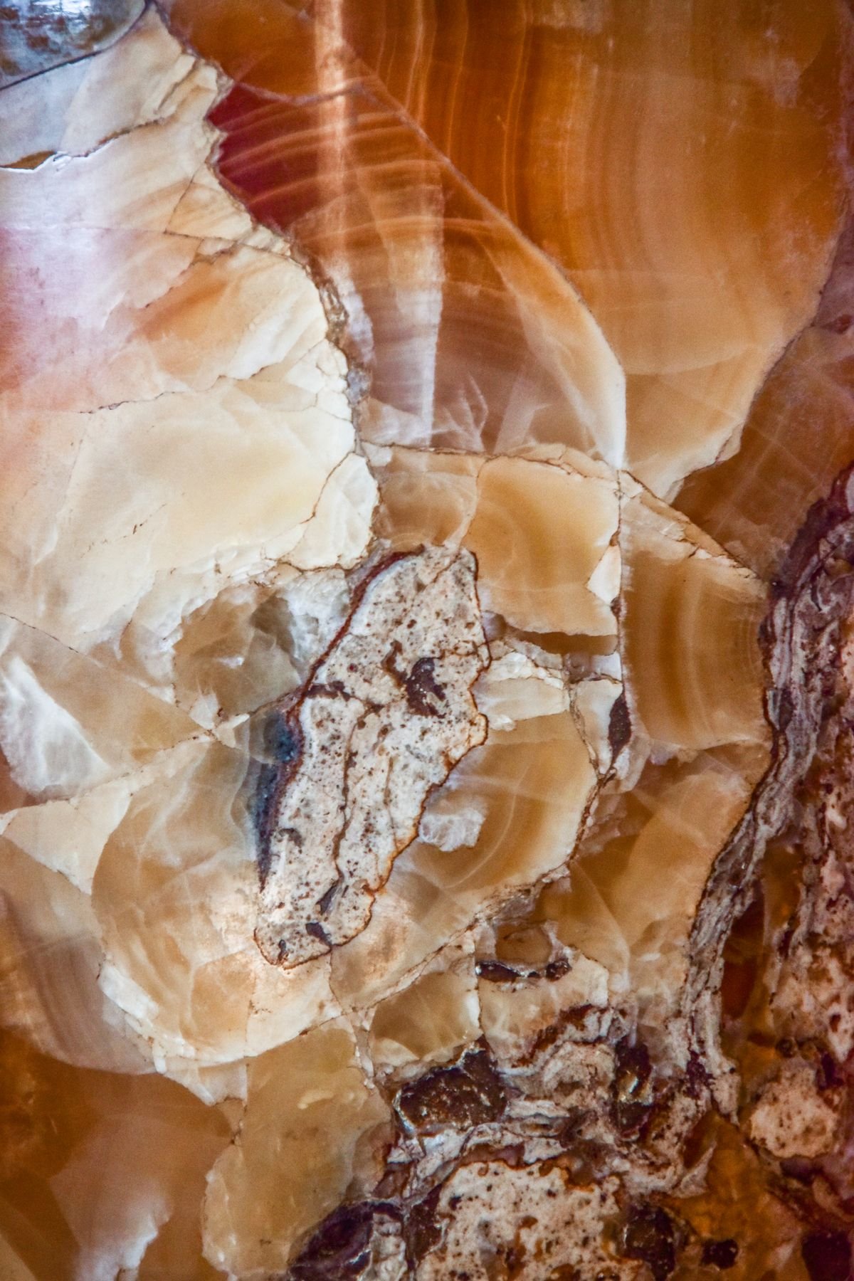 Close-up of onyx stone showing natural patterns and rich colours