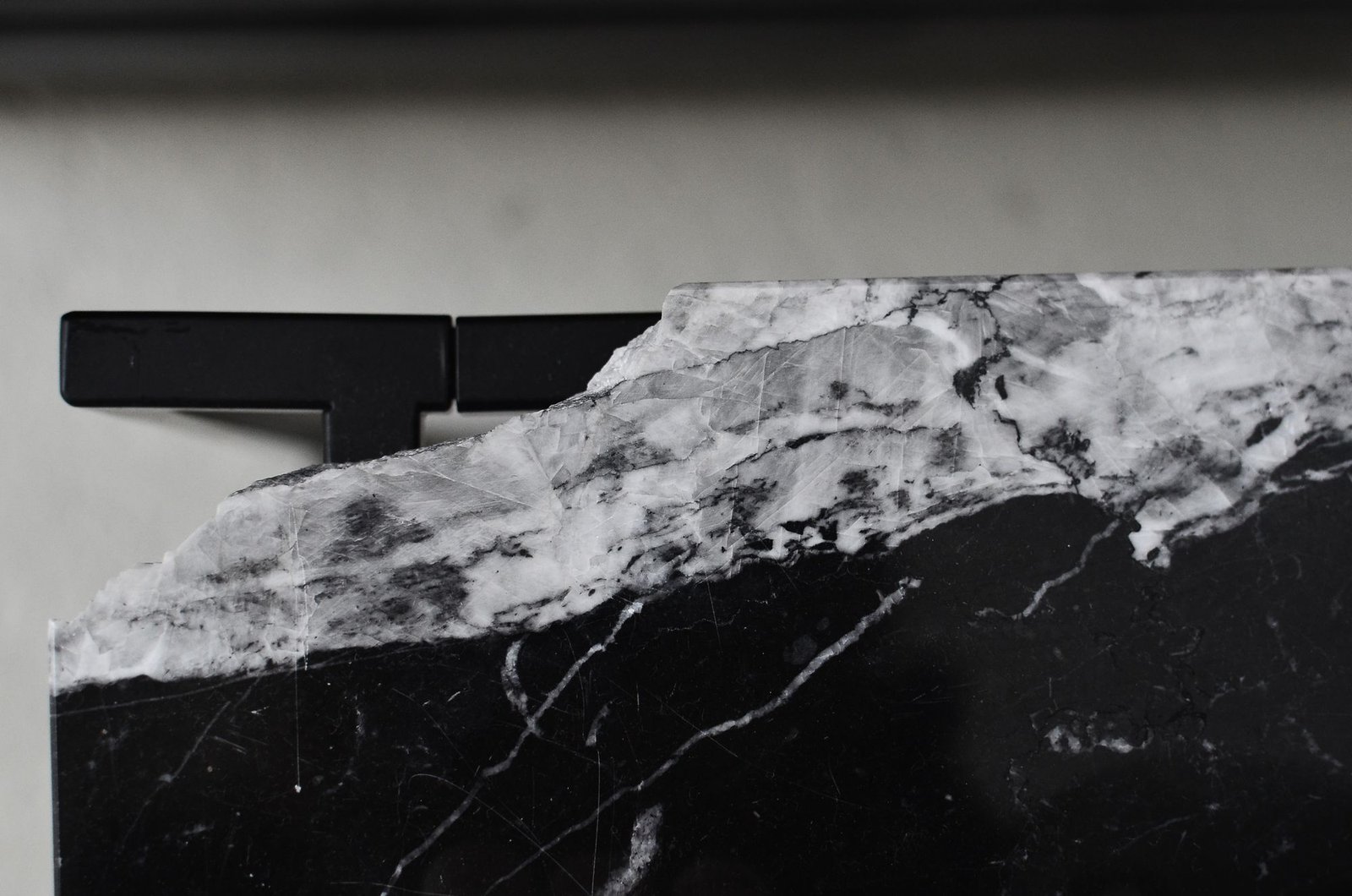 Aged marble table surface with visible wear, cracks, and curved lines