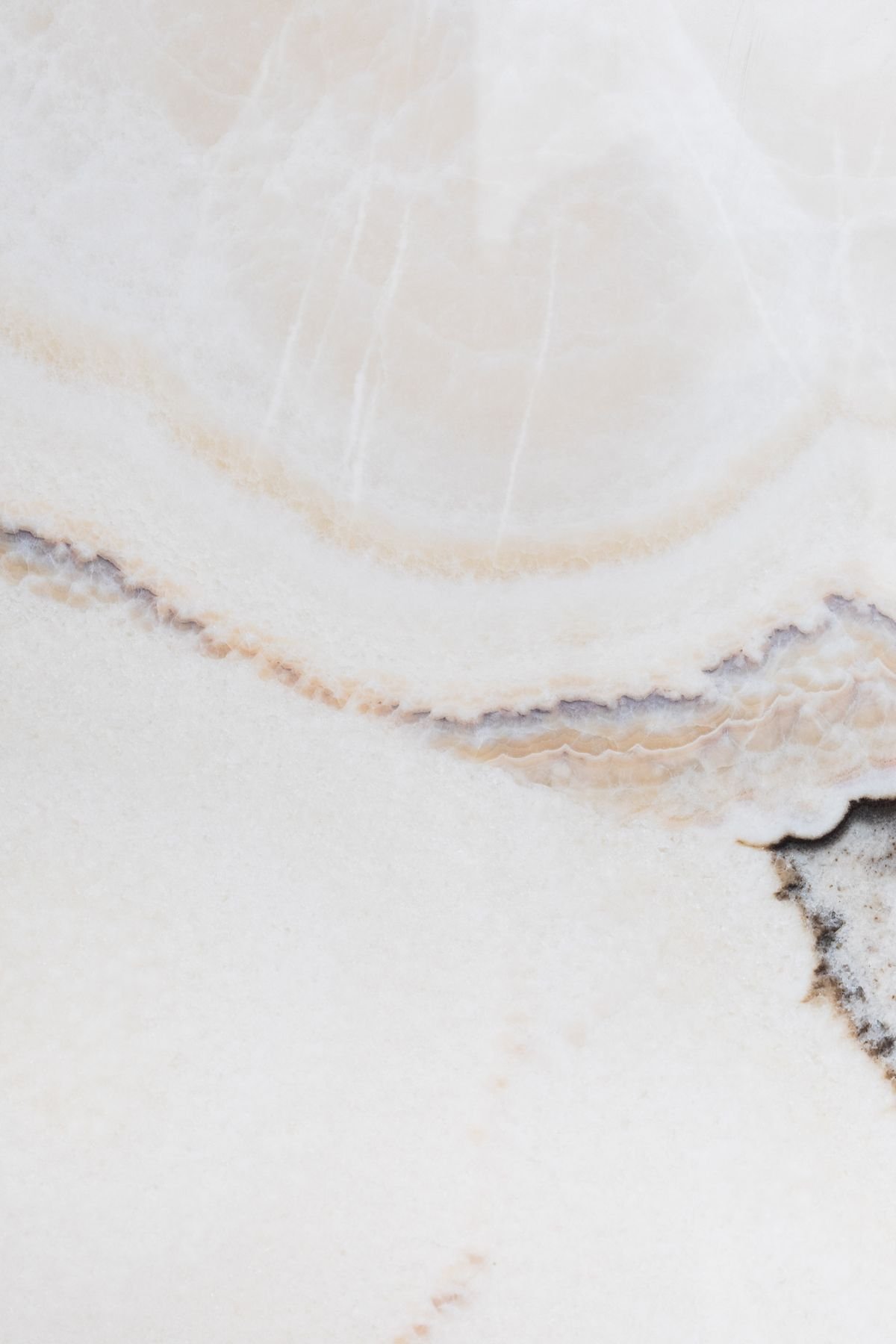Cream and beige onyx-like marble surface with soft natural banding