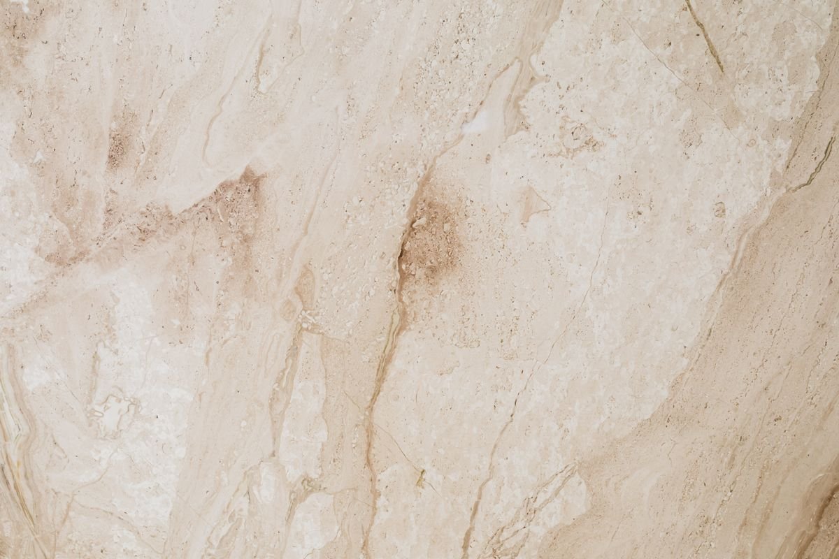 Close-up of polished beige marble with natural flowing patterns