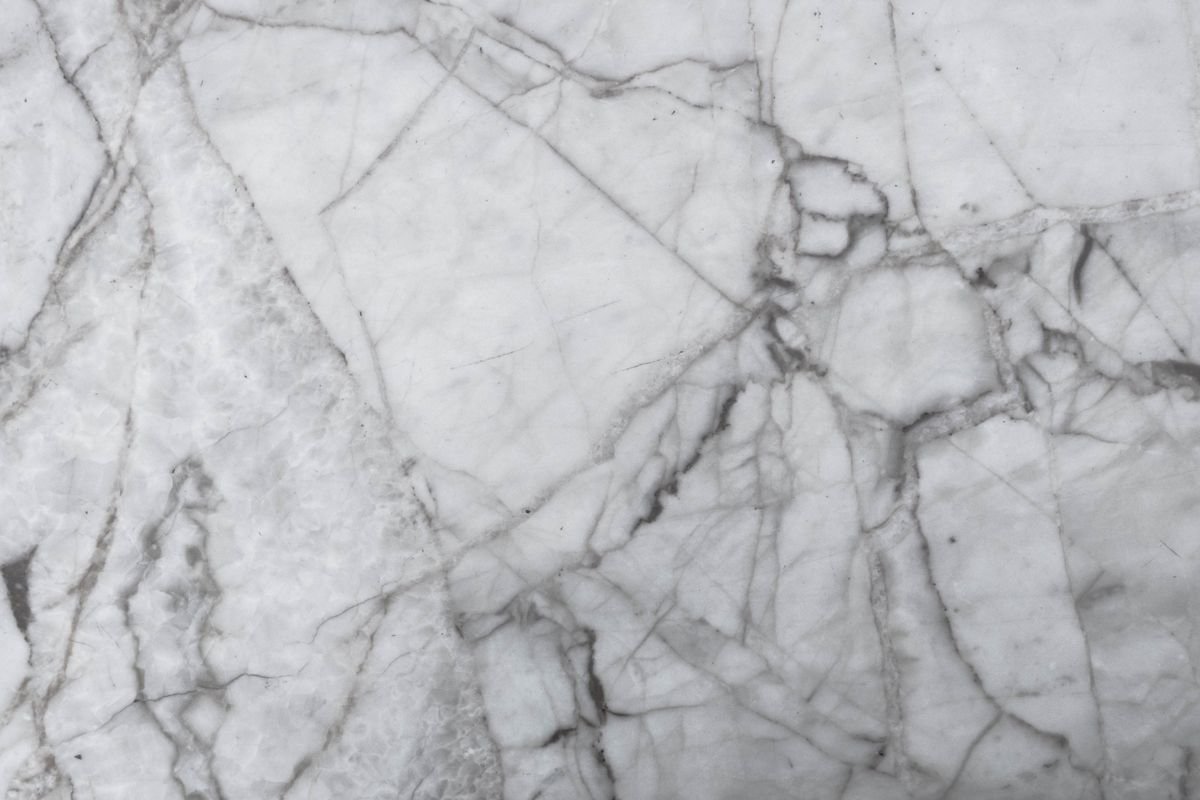 White marble surface with striking natural grey crack patterns