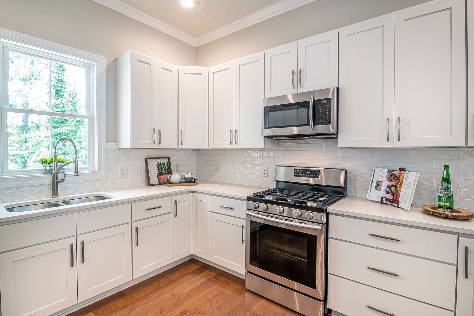 Stainless steel microwave oven above a gas range in a modern kitchen