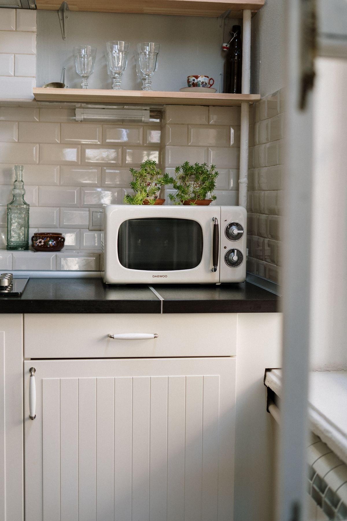 Microwave oven on a kitchen shelf