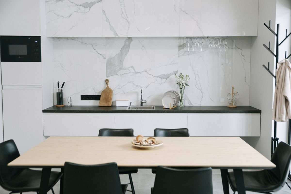 Japandi-style kitchen with marbled walls and a dining setup