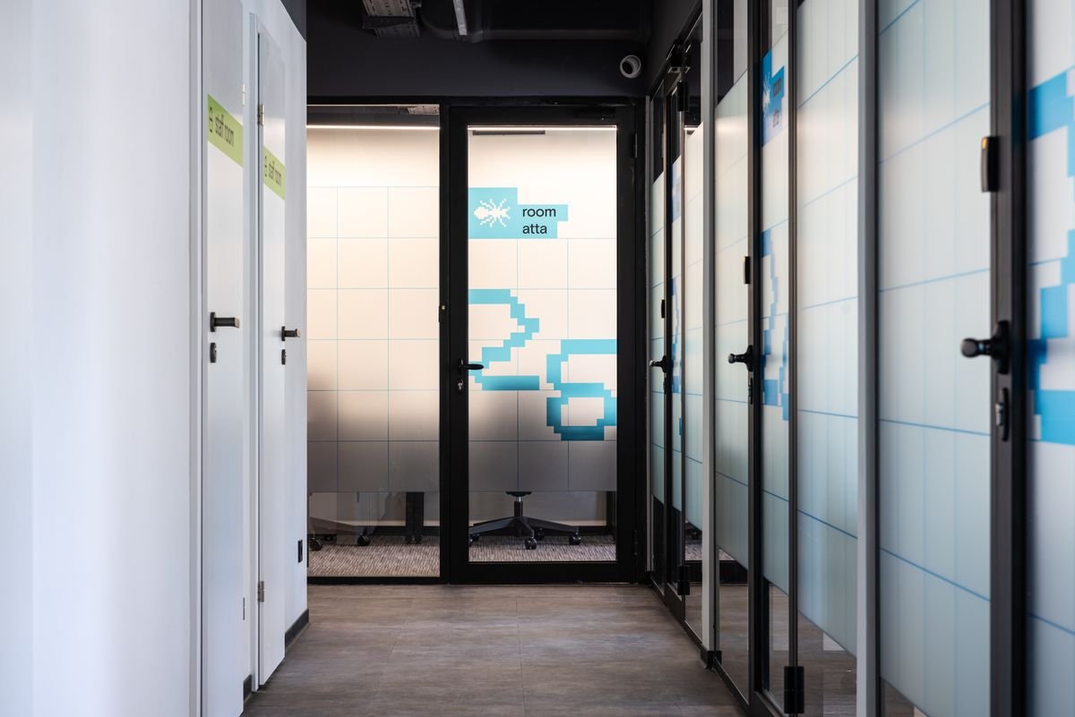 Glass office door with branded graphics in a modern office fit-out