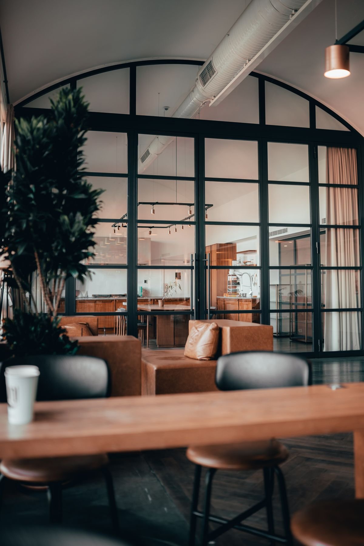 Open-plan space with glass partitions and leather furniture