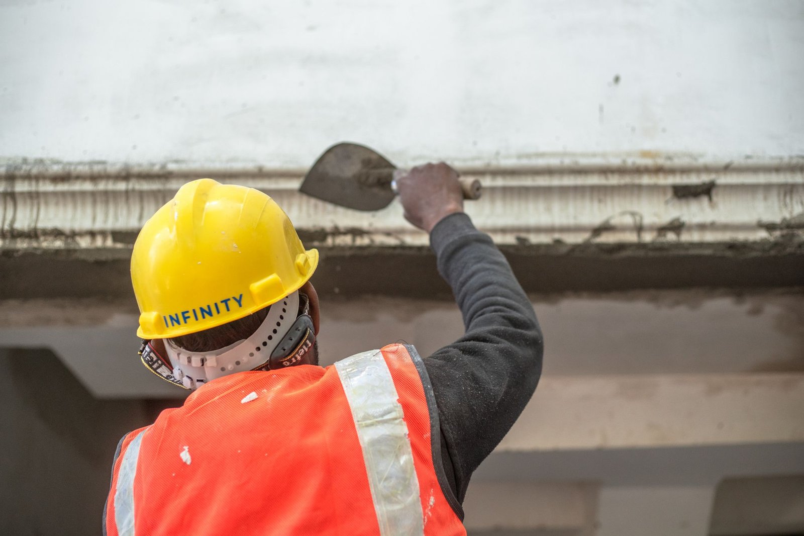 Construction worker plastering an interior wall