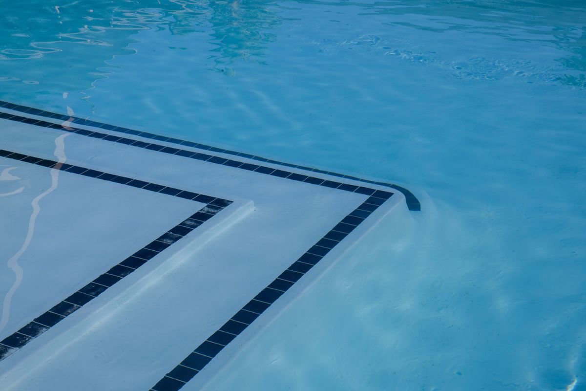 Clear blue swimming pool with tiled steps and shimmering water