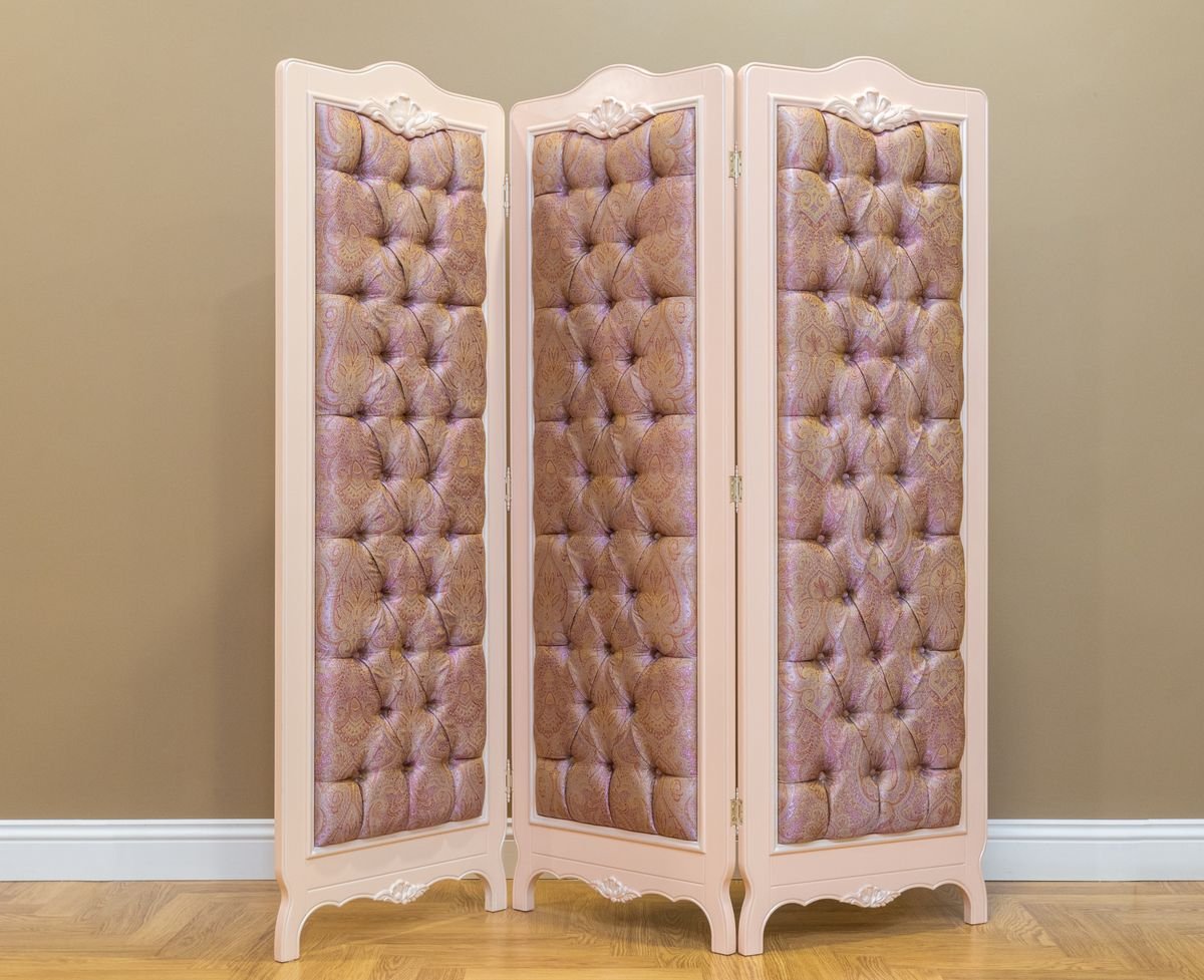 Tufted fabric folding screen in a classic dressing room with a wooden floor