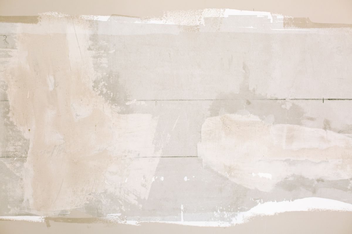 Close-up of a skim-coated wall showing a smooth, level finish