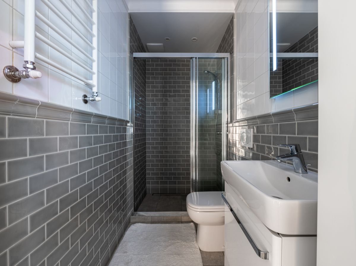 Bathroom with gray subway wall tiles and glass shower v2