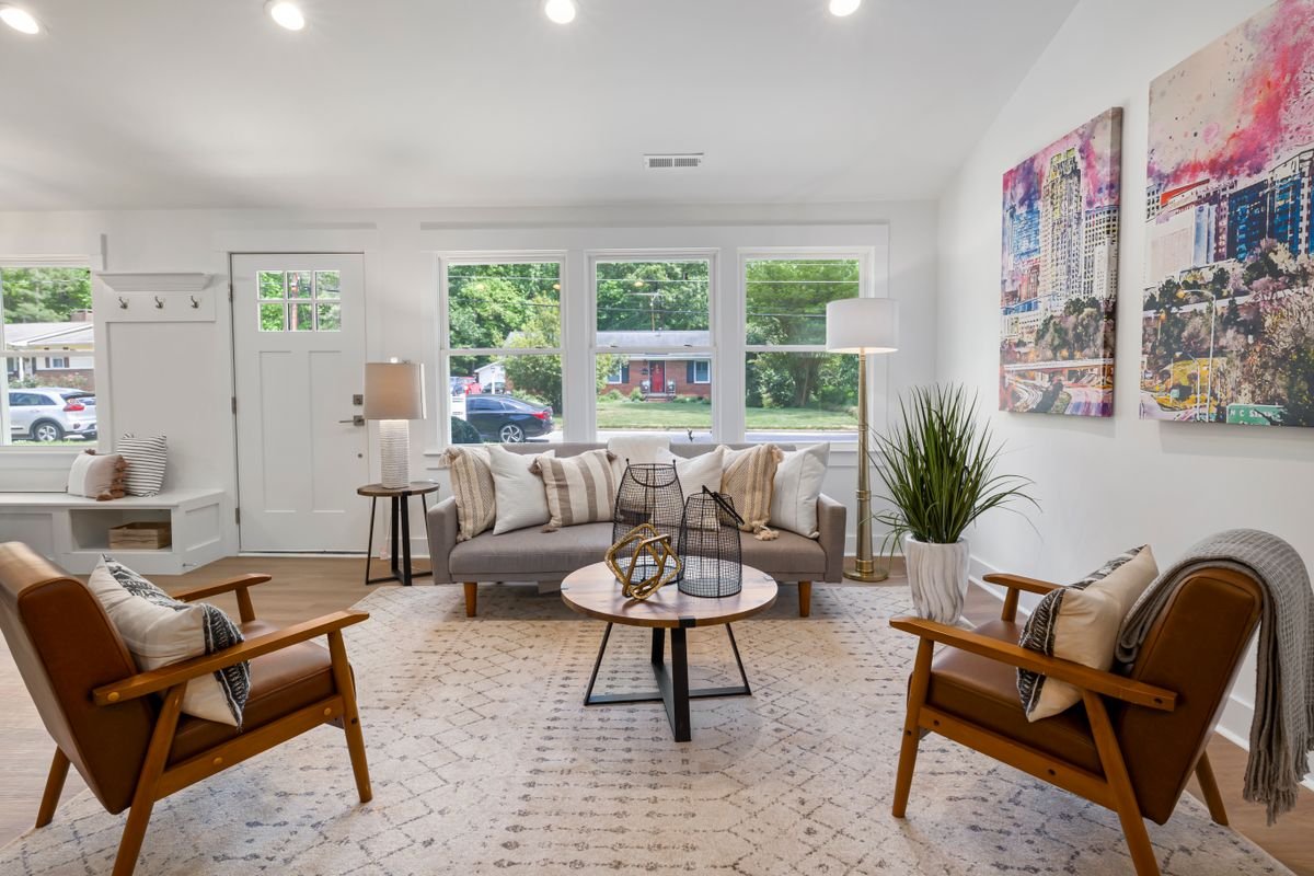 Bright living room with white painted walls and large windows