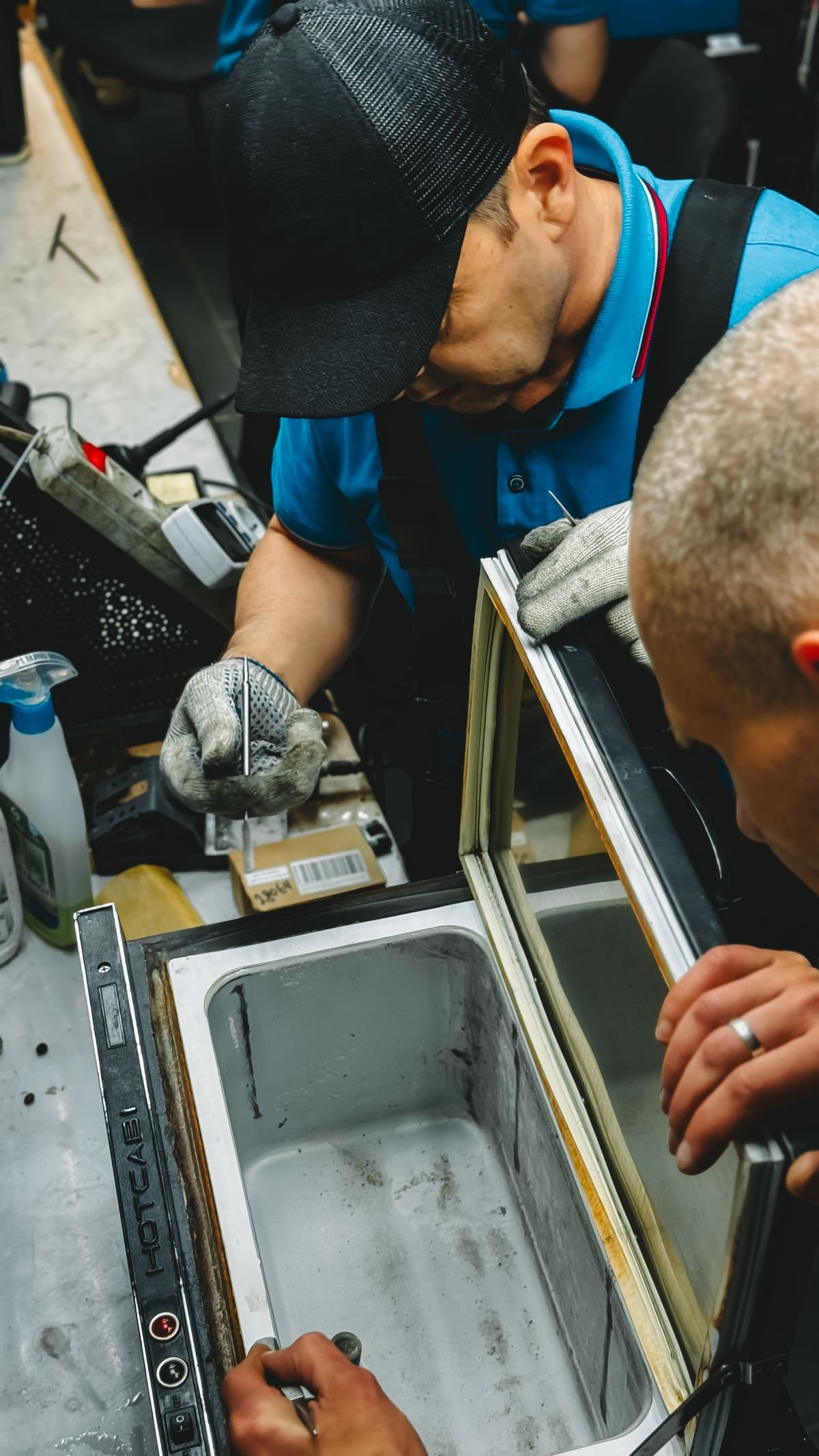 Technicians servicing a walk-in chiller