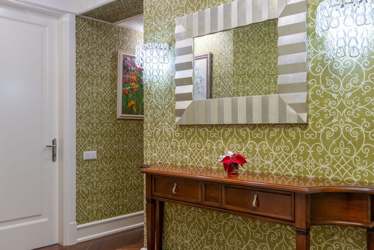Sophisticated hallway featuring ornate patterned wallpaper