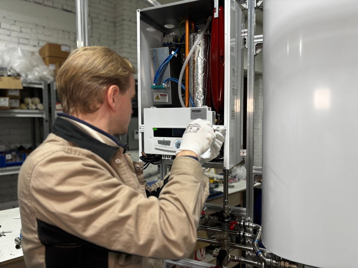 Technician repairing a heating system component in a workshop