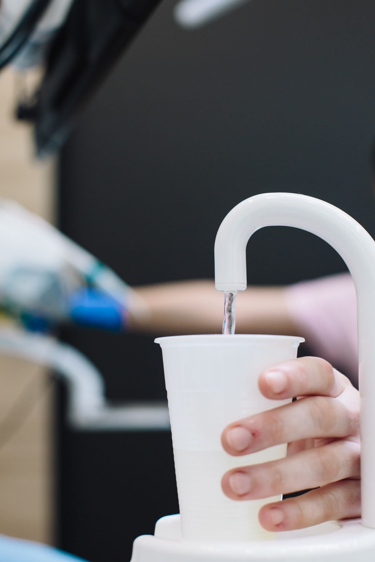Person using a point-of-use water dispenser