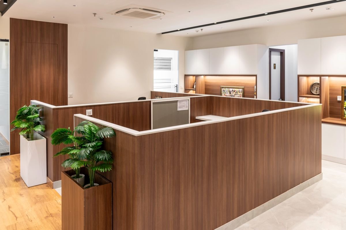 Bright modern office interior with wooden slat partitions and warm decor
