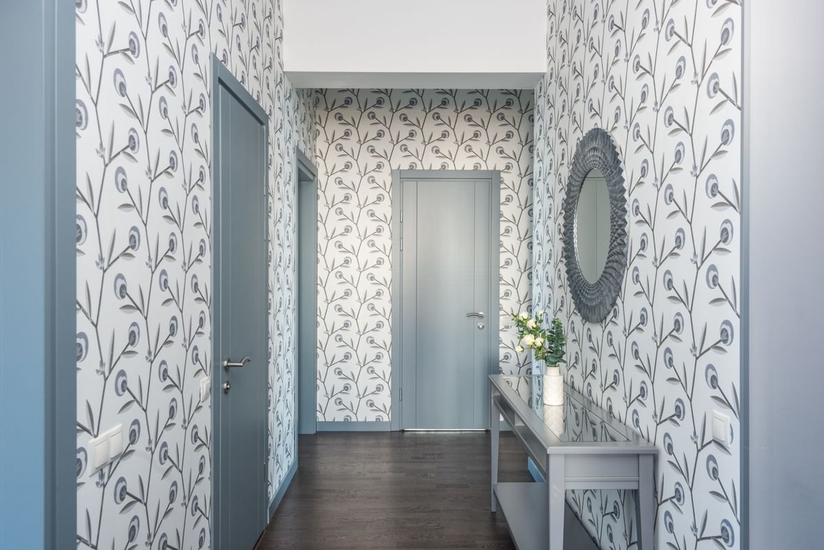 Hallway with botanical pattern wallpaper matched neatly across doors and corners