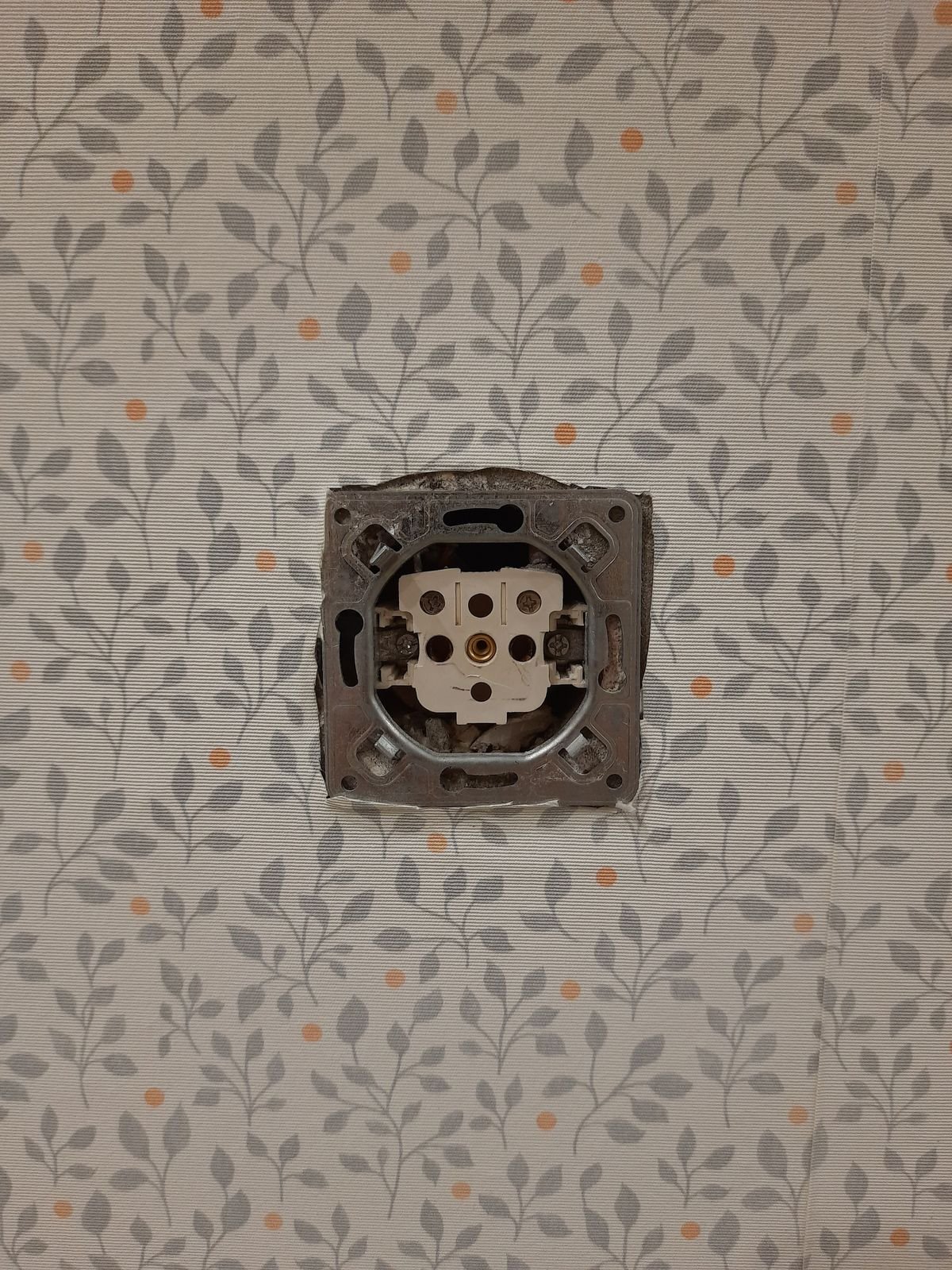 Patterned wallpaper with a clean cut-out around an electrical socket