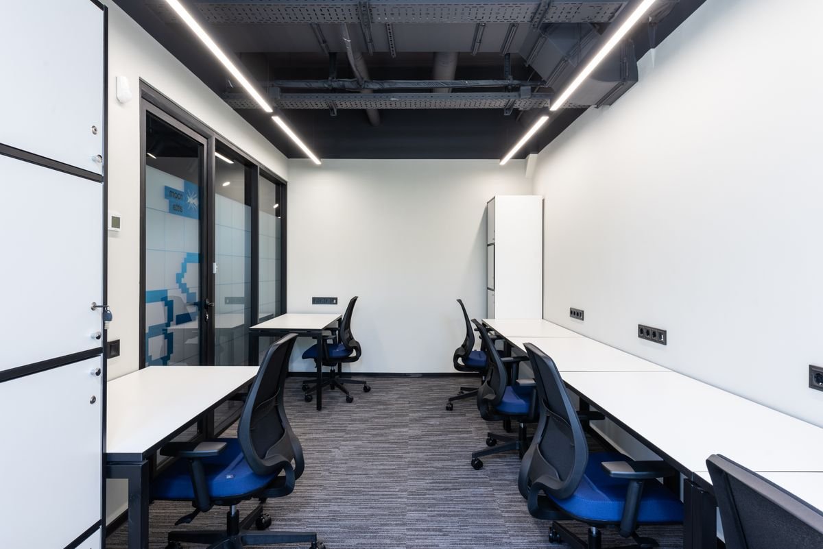 Open-plan office with branded graphics on glass and clean white walls
